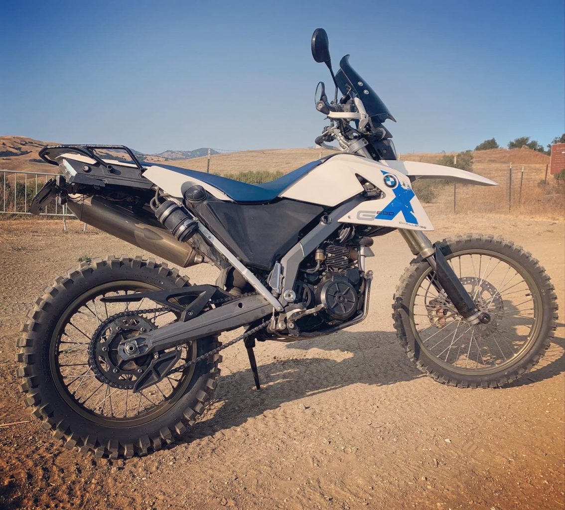 BMW G 650 Xchallenge motorcycle idles on the side of an off-road motorcycle trail at at Metcalf Motorcycle County Park, Santa Clara County, California